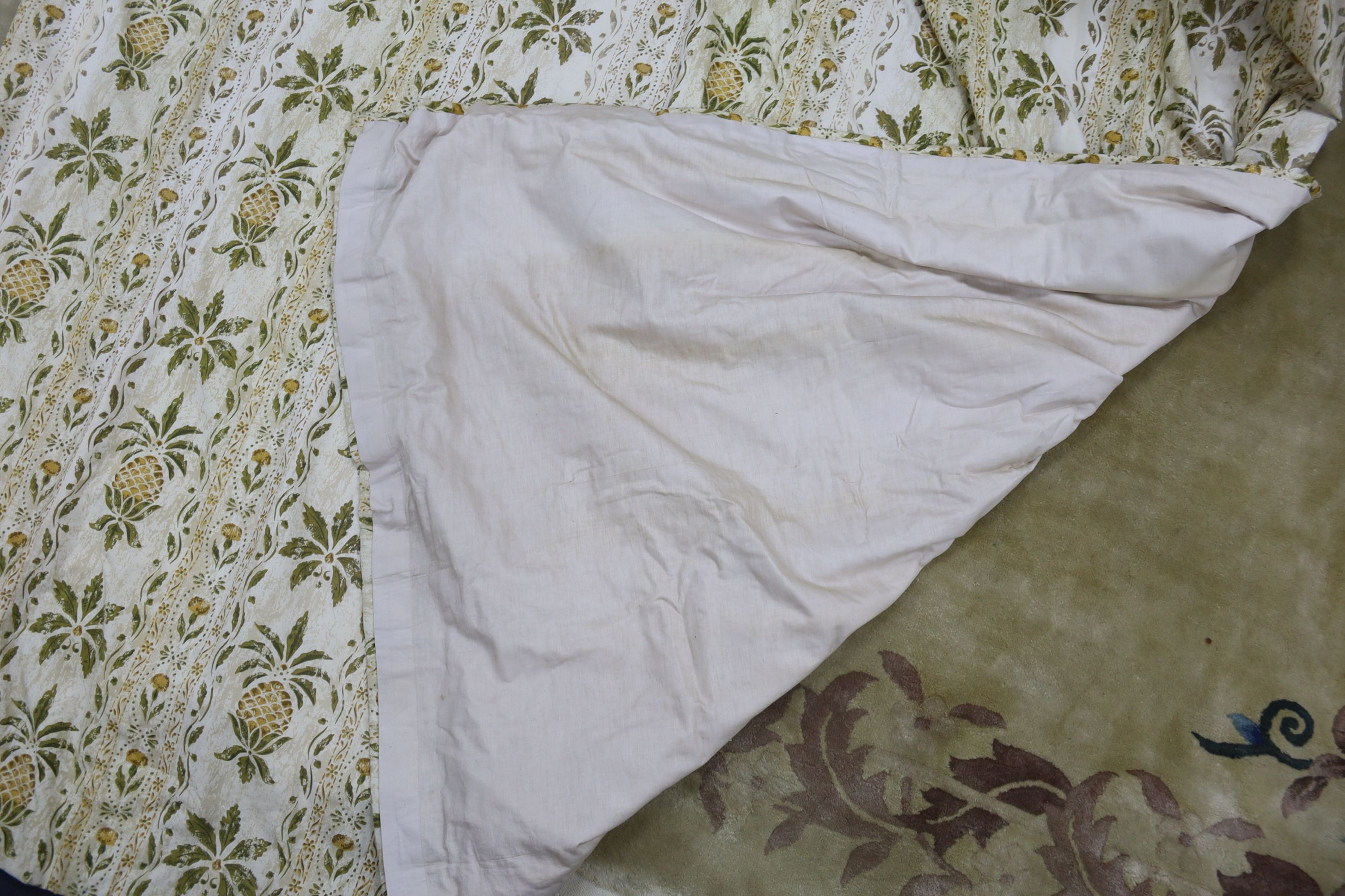 A pair of linen, 'Morris' style curtains and another pair of cotton curtains with a pineapple design